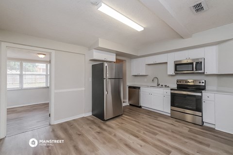 the kitchen of our studio apartment atrium with stainless steel appliances and white cabinets