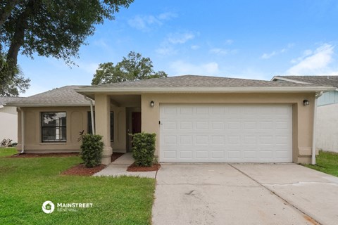 a beige house with a white garage door