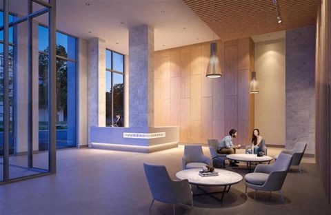 Two people sitting at a table in a modern lounge area.