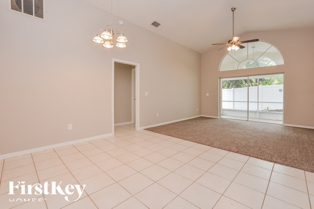 a living room with a door to the dining room