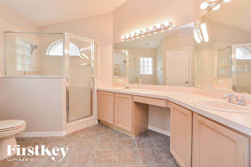 a bathroom with a large mirror and a toilet and a sink