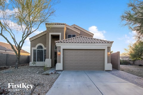 a home with a garage door and a driveway
