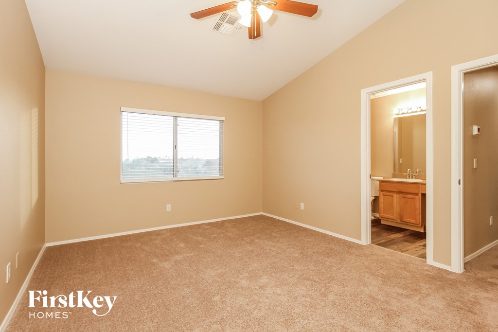 the master bedroom is spacious and has a ceiling fan