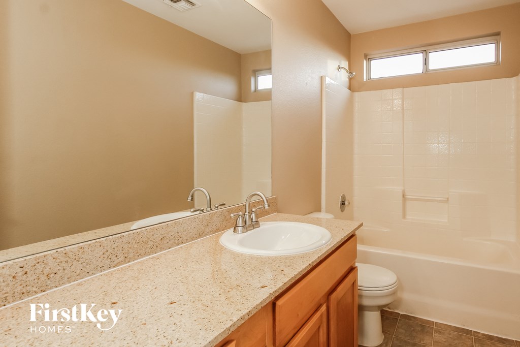 a bathroom with a sink and a shower and a toilet