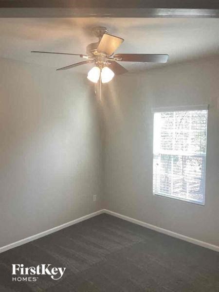 a white room with a ceiling fan and a window