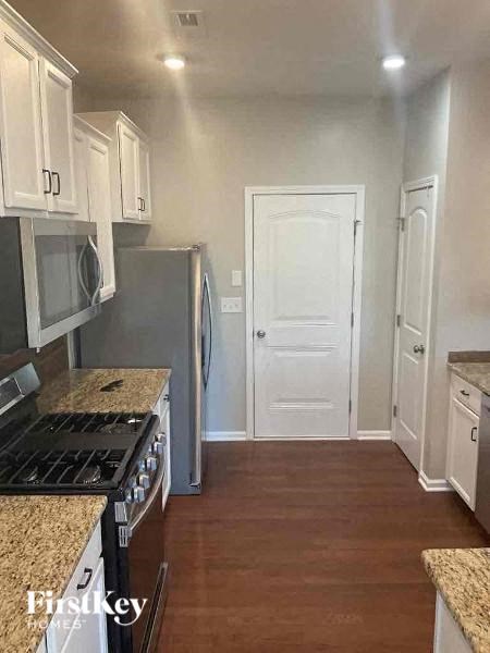 a kitchen with a stove and a refrigerator and a door