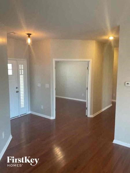 an empty living room with a hard wood floor