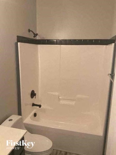 a white bathroom with a shower and a toilet