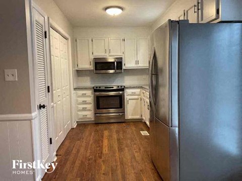 a kitchen with stainless steel appliances and white cabinets