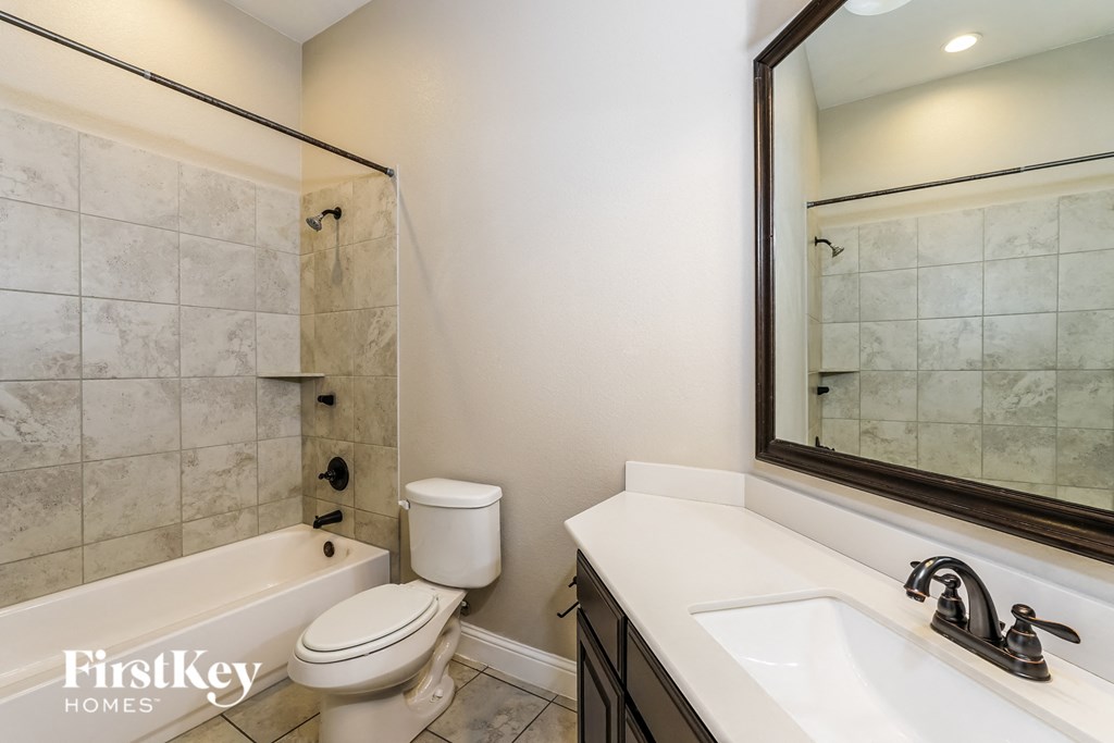 a bathroom with a sink toilet and a shower