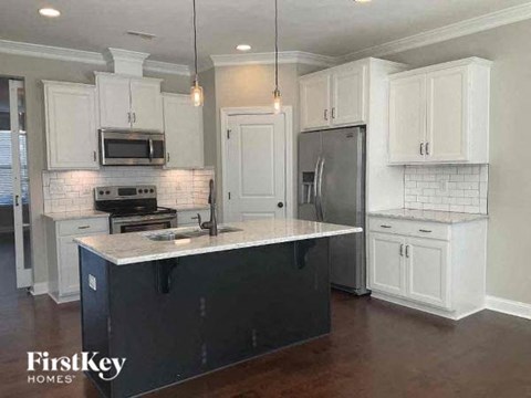 a kitchen with white cabinets and a counter top