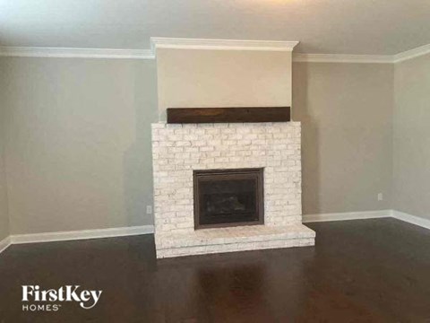 a fireplace in a living room with a wooden floor
