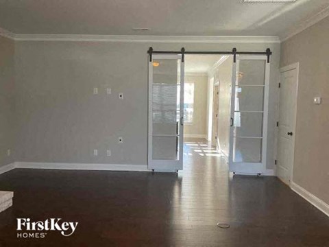 an empty living room with a sliding glass door