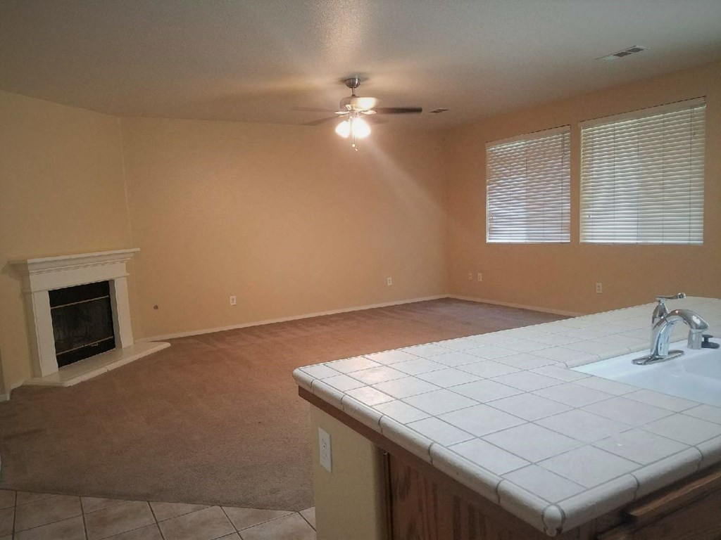 an empty kitchen and living room with a fireplace