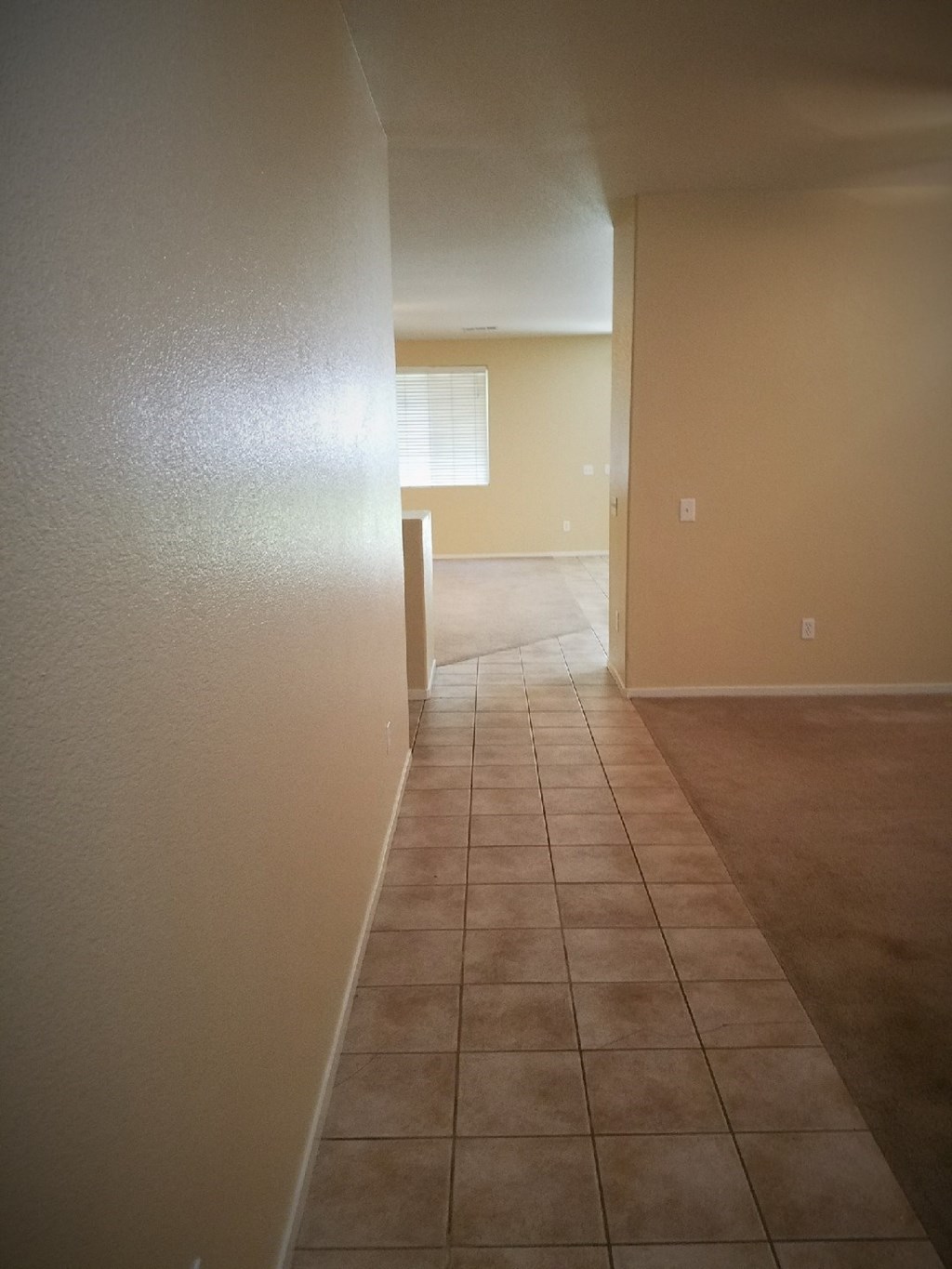 a view of the living room and dining room of an empty house