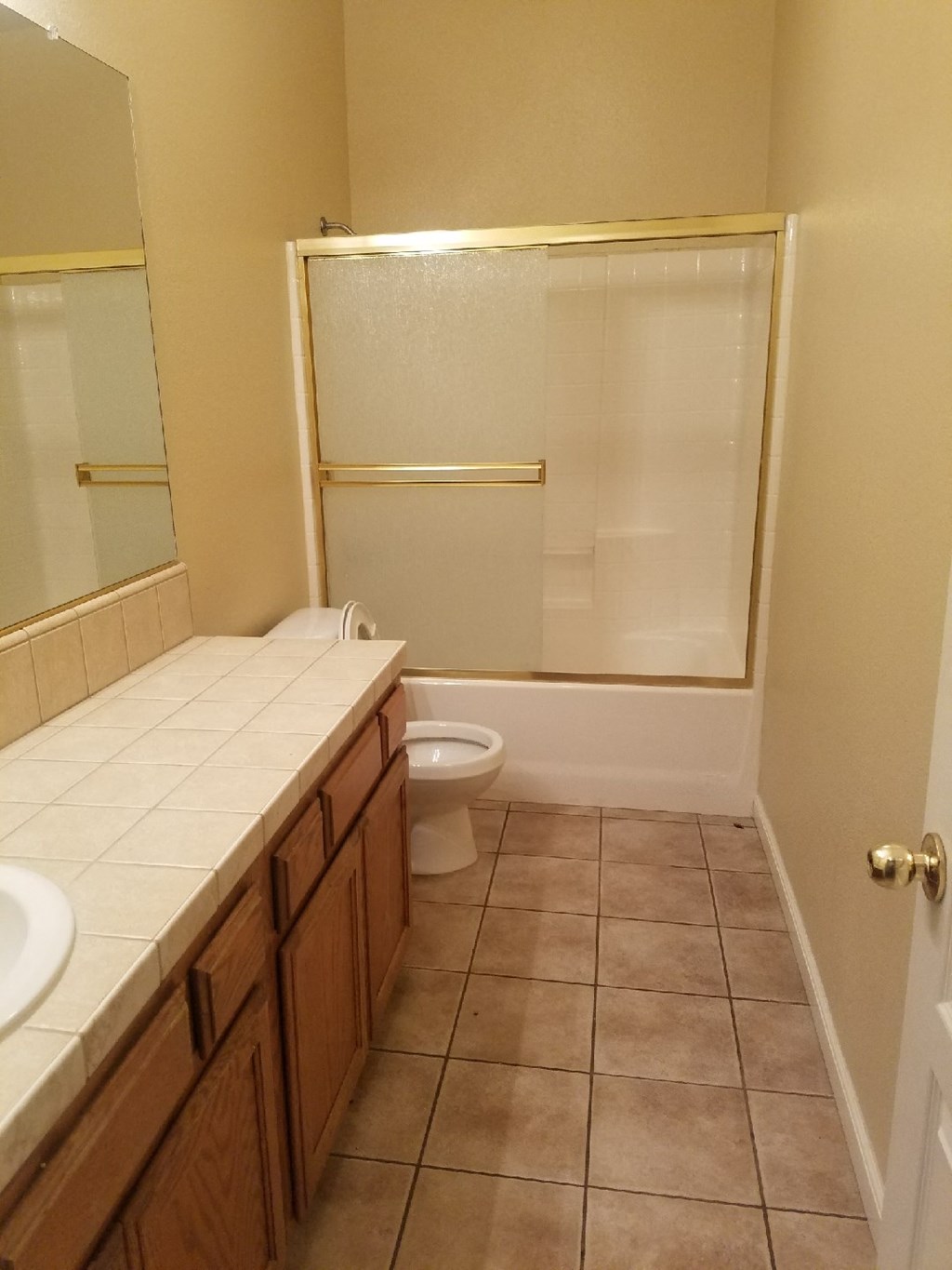 a bathroom with a toilet and a sink and a shower