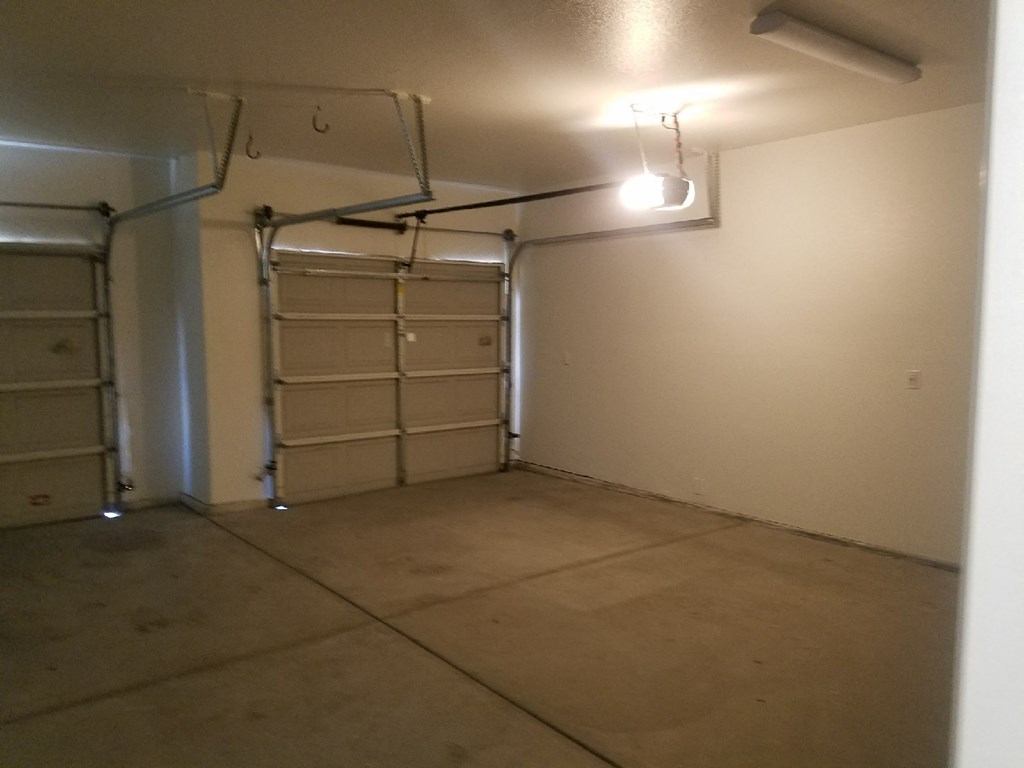 an empty garage with empty shelves and a light on the ceiling
