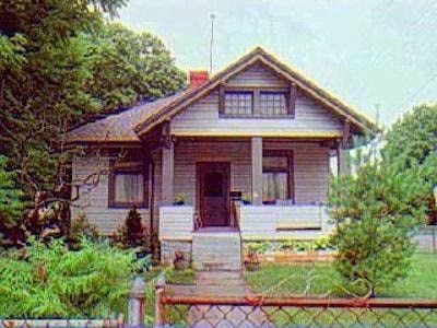 a small house with a fence in front of it