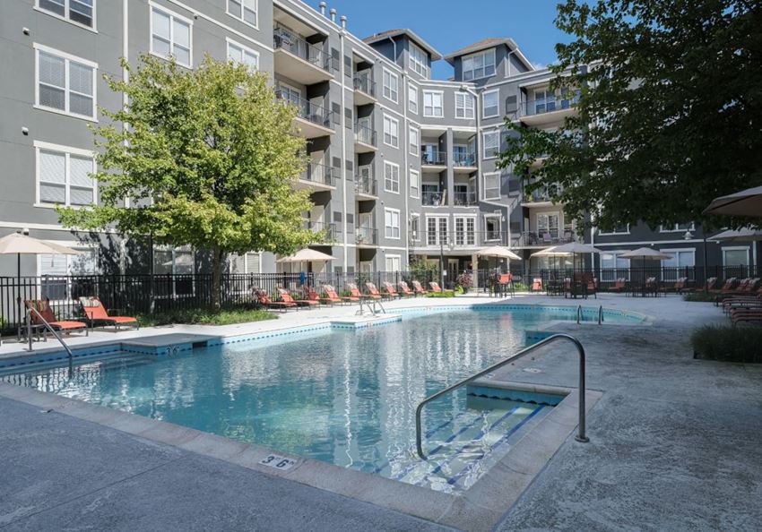 a swimming pool in front of an apartment building