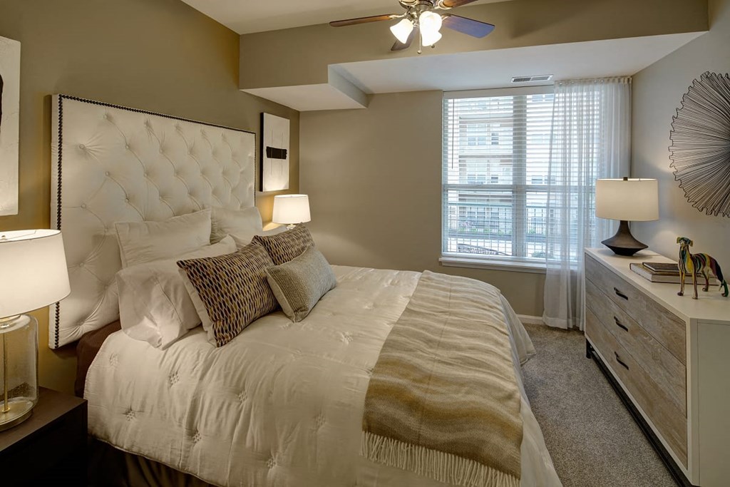 a bedroom with a large bed and a ceiling fan