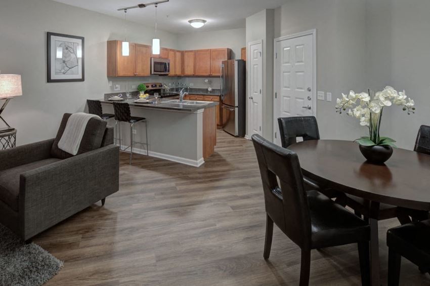 a dining room and kitchen with a table and chairs