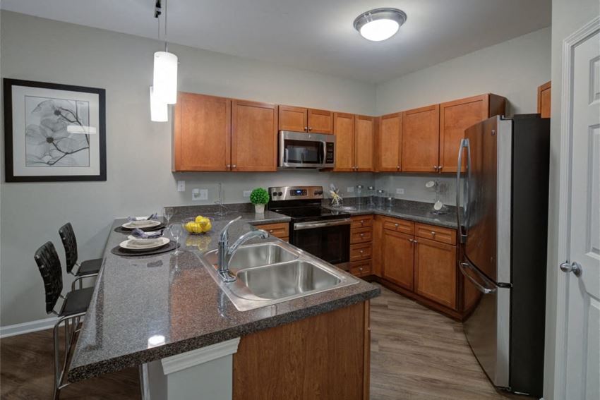 a kitchen with stainless steel appliances and granite counter tops