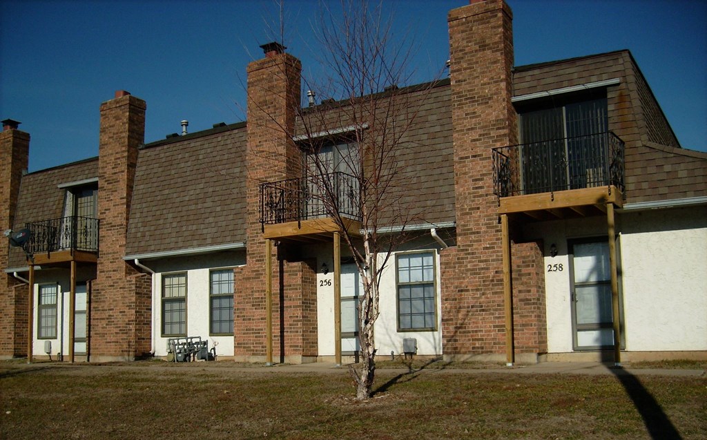 a brick building with a tree in front of it