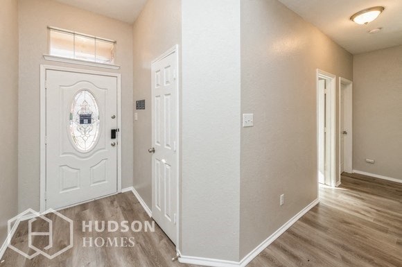 the entrance to a home with a white door