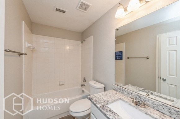 a bathroom with a sink and a toilet and a bath tub