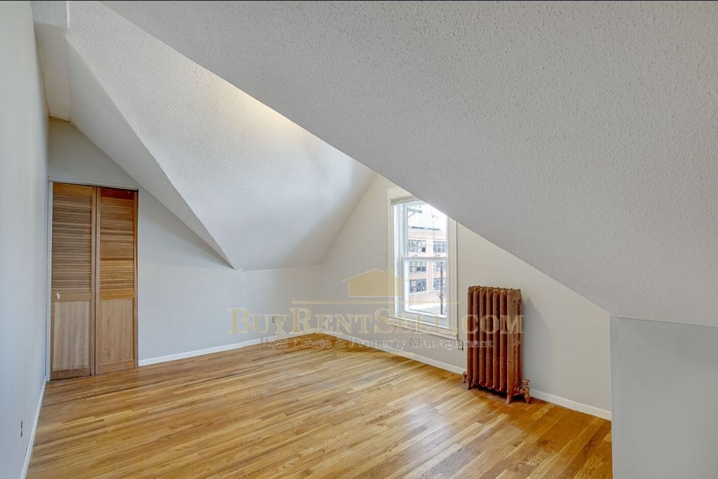 a room with a hard wood floor and a window