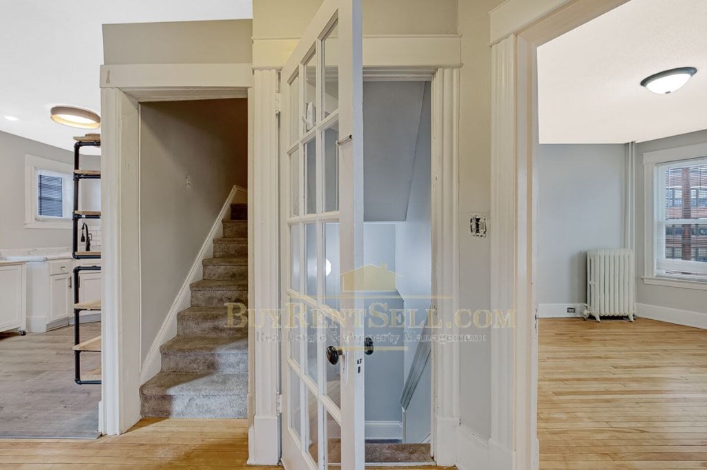 a renovated house with a staircase and an open door