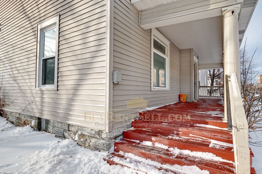 a home with red steps in the snow