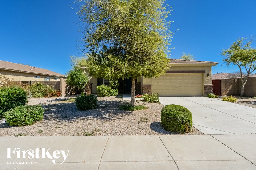 A house with a tree in front and a sign that says "FirstKey Homes".