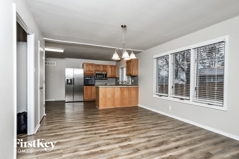A spacious kitchen with wooden cabinets and a central island.