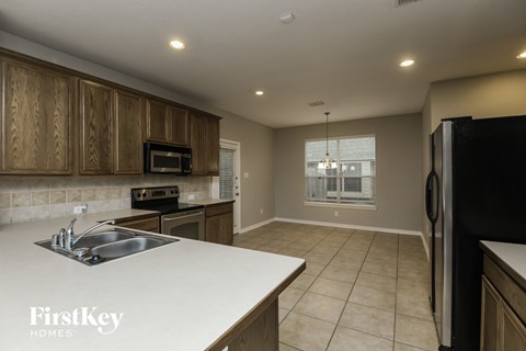 a kitchen with a white counter top and a sink