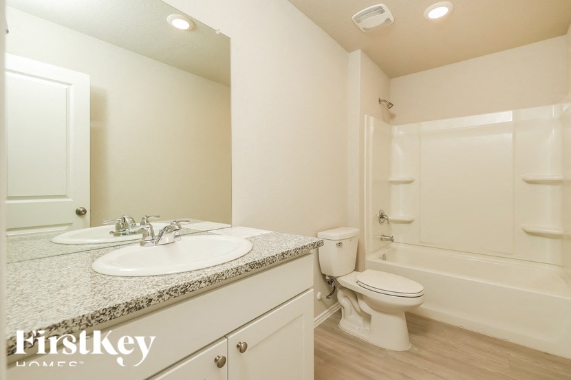 A bathroom with a sink, toilet, and bathtub.