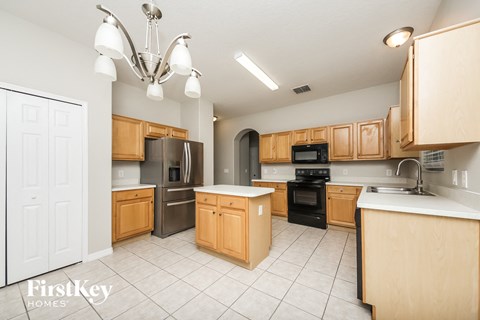 a kitchen with wooden cabinets and stainless steel appliances