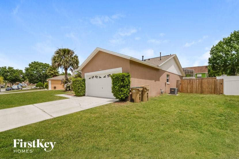A house with a garage and a driveway in front of it.