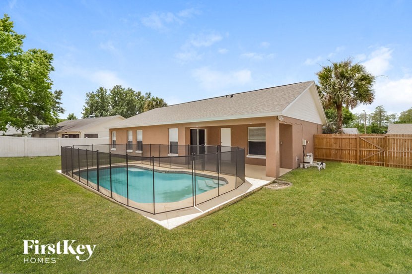 A house with a pool in the backyard.