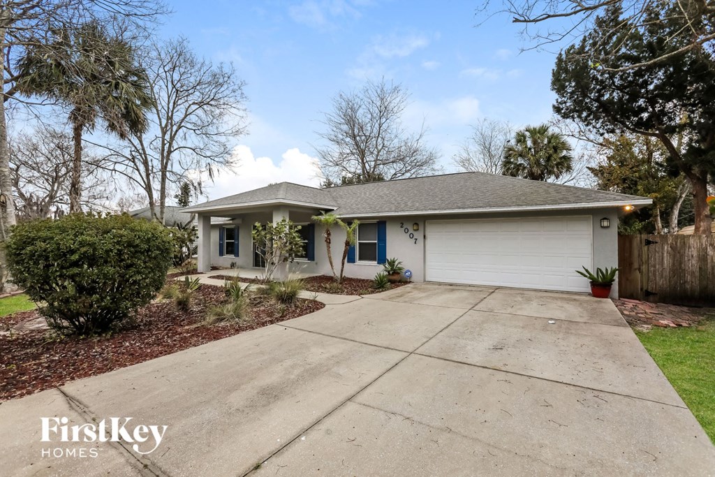 a white house with a driveway and a garage door