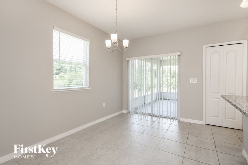 an empty living room with a door to a patio