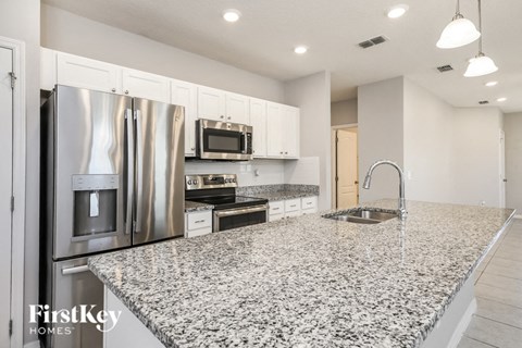 a kitchen with granite counter tops and stainless steel appliances