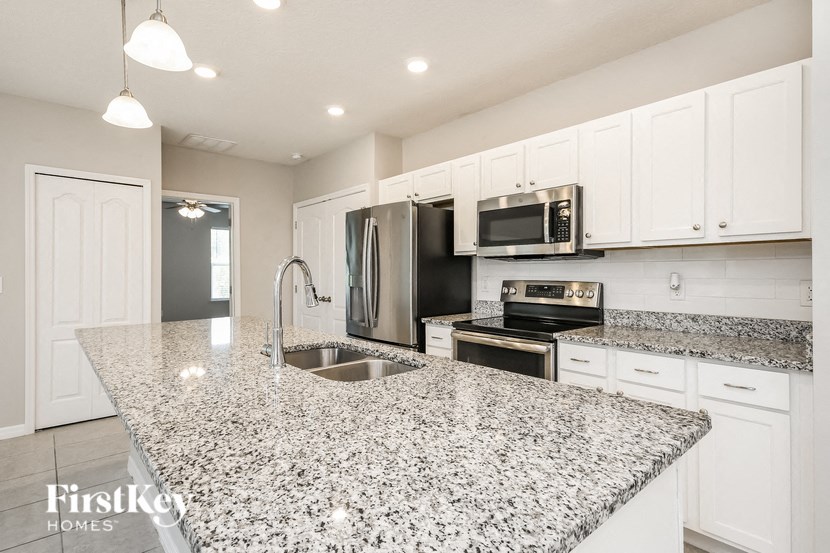 a kitchen with a granite counter top and a sink