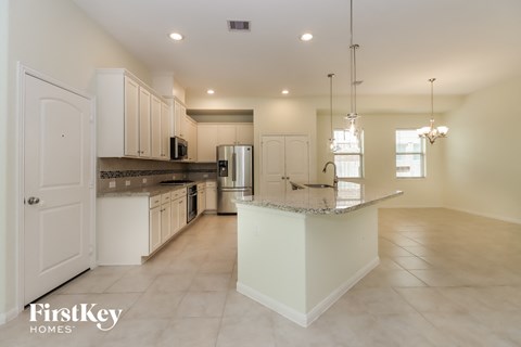 A spacious kitchen with a large island in the middle.