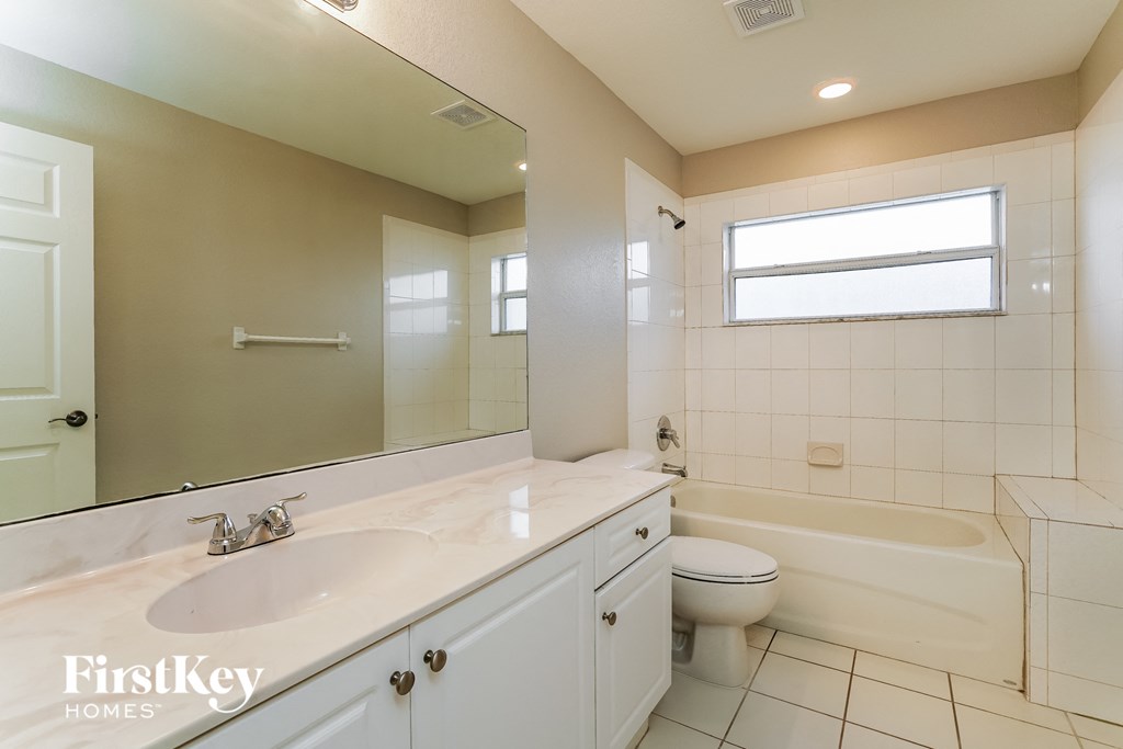 a bathroom with a sink and a toilet and a tub