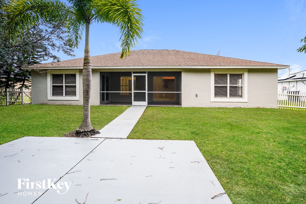 a white house with a palm tree in front of it