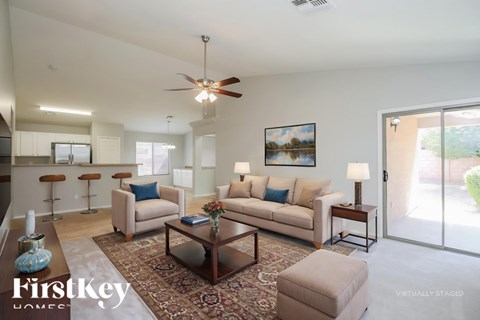 A living room with a couch, a coffee table, and a painting on the wall.