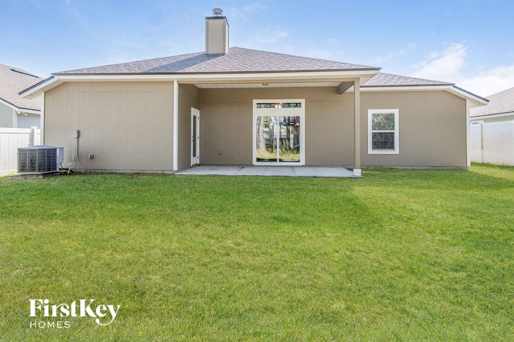 A house with a brown roof and a white garage door.