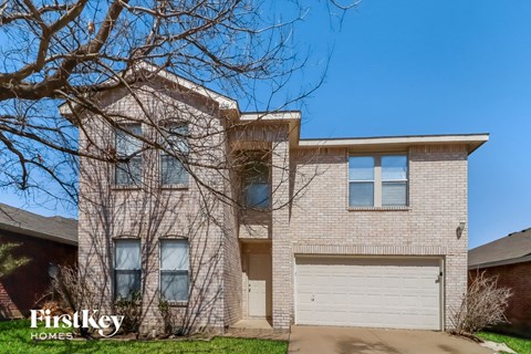 a white brick house with a white garage door