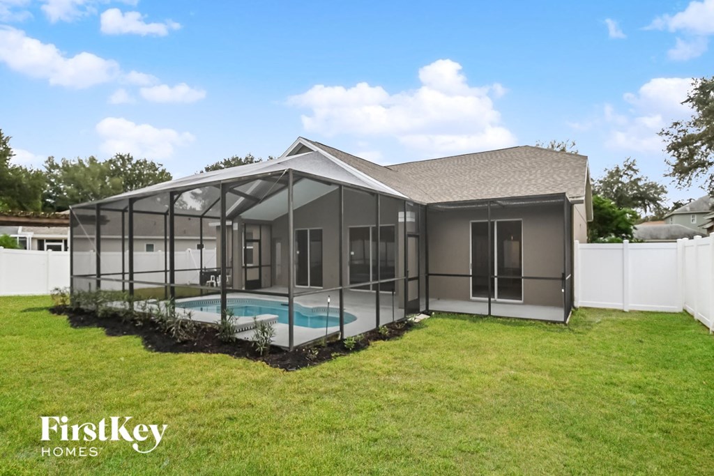 a screened in pool in the backyard of a house